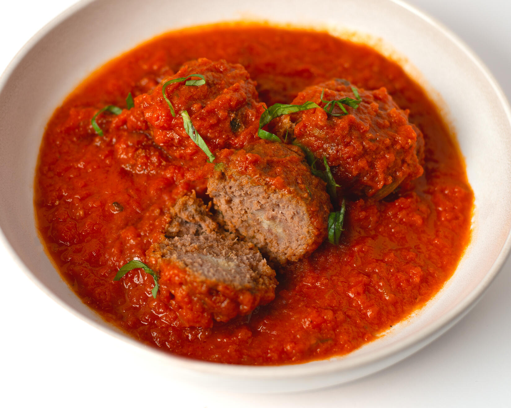 Slow-Simmered Beef Meatballs Our beef meatballs are slow-simmered in a bright tomato sauce until tender and flavorful. Served warm and saucy, they are rich, comforting, and made to pair perfectly with our house-made focaccia.